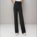 Detail view of women's high-waisted straight trousers with multiple pockets and buttons. - S / Bottoms / Black