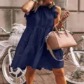 Outdoor lifestyle detail view of the elegant sleeveless navy blue tiered ruffle midi dress. - S / Dresses / Dark Blue