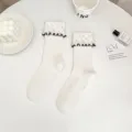 White mid-tube socks for women featuring elegant pearl embellishments and black ruffle lace edges. - One Size (EU 34-39) / White