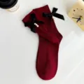 Dark red mid-tube socks featuring elegant black bows and sweet hanging pearls for women. - One Size (EU 34-39) / Burgundy