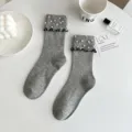 Grey knit mid-calf socks for women featuring elegant pearl embellishments and black ruffled cuffs. - One Size (EU 34-39) / Light Gray