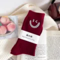 Red ribbed mid-calf socks featuring sparkling rhinestone wink smile design with paper packaging tag - One Size (EU 34-39) / Burgundy