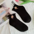 Chic black socks featuring delicate ruffled cuffs and cute floral embroidery design. - One Size 34-39 / Black