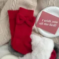 Red cotton mid-calf socks featuring a sweet plush bow design, cozy winter hosiery variant. - Vertical Stripe Bow