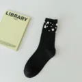 Black mid-calf socks for women featuring elegant faux pearl embellishments, chic style. - One Size (EU 34-39) / Black