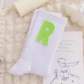 White mid-calf socks for women featuring a stylish green letter R patch, cute Japanese style design. - One Size 34-39 / White Sock Green R