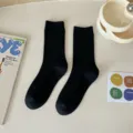 Black ribbed mid-tube socks for women, solid color cotton knit casual daily wear hosiery. - Black