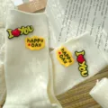 Women white mid-tube slouch socks with cute letter silicone badges, stylish everyday wear. - One Size 34-39 / Milk White