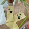 Yellow mid tube socks featuring cute smiley faces and graphic numbers print, casual and stylish. - One Size 34-39 / Light Yellow