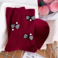 Maroon knitted crew socks with black-white plaid bows and pearl decorations, cozy winter style. - One Size (EU 34-39) / Burgundy