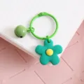 Llavero de metal color caramelo con campana verde y colgante de flor para bolsos. - Flor De Campana Verde