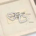 Dettaglio moschettone a molla in lega a forma di cuore, finitura argento e dimensioni. - Cuore
