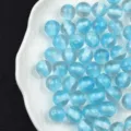 Close-up detail of light blue glitter resin beads showcasing sparkly starry texture for DIY. - 16mm / 11# Blue - Candy Core