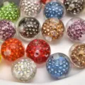 Detailed close-up of colorful rhinestone pavé disco balls, crystal DIY jewelry making beads. - Multicolor