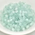 Close-up view of 4mm light green cat eye glass spacer beads for DIY craft jewelry making. - 4mm / Light Blue