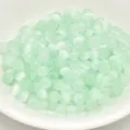 Close-up of 4mm mint green brushed cat-eye glass beads, perfect for DIY jewelry and crafts. - 4mm / Light Green