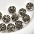 Macro detail shot of 16mm transparent rhinestone paved round beads for DIY jewelry making. - Black