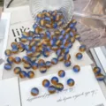 Detailed close-up of blue and gold gradient starry resin beads for DIY jewelry crafts. - Royal Blue & Orange