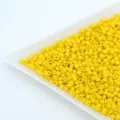 Close-up detail view of vibrant yellow glass seed beads for crafting jewelry parts - Lemon Yellow