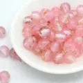 Close-up detail of pink resin loose beads with fine glitter, gold foil, and white stripes. - 8mm / Aperture Approx. 1.6mm / Pink