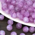 Close-up detail of purple glitter resin round beads, perfect for DIY jewelry making. - Purple Rose