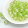 Closeup detail of glittering green resin beads with gold foil flakes for DIY handmade jewelry crafts. - 8mm / Aperture Approx. 1.6mm / Green