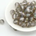 Close-up detail of grey translucent resin beads featuring gold foil flakes and fine glitter. - 8mm / Aperture Approx. 1.6mm / Starry Gray