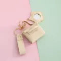 Llavero de mini bolso de piel PU con espejo de flor. Accesorio perfecto para llaves y bolsos. - Blanco Roto