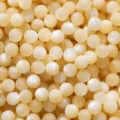 Close-up van gele ronde harskralen DIY sieraden maken benodigdheden glinsterende textuur - Lichtgeel