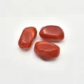 Close-up detail of irregular red imitation stone acrylic beads for DIY handmade jewelry accessories. - Brick Red