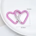 Close-up detail of pink heart shaped metal carabiner hook for DIY crafts and accessories. - Large Bright Pink Hearts