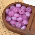 Close-up detail of starry glitter resin beads, large hole abacus wheel shape for DIY craft. - Violet