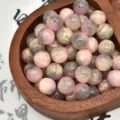 Close-up detail of colorful resin beads with pink grey and gold swirled patterns for DIY crafts. - Pink and Gray