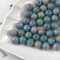 Close-up of marbled blue resin round beads with artistic oil painting texture for jewelry DIY. - Summer Night