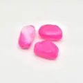 Close-up detail of irregular acrylic pink imitation stone beads for DIY jewelry making. - Glitter