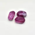 Close-up of purple swirled acrylic beads with pre-drilled hole for DIY jewelry making crafts. - Fuschia