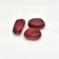 Closeup detail of red marbled acrylic irregular stone beads for DIY jewelry making. - Dark Red