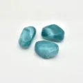 Close-up detail of irregular cyan swirled acrylic beads, smooth finish, ideal for jewelry. - Kingfisher Blue