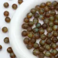Detail shot of sparkling brown resin beads with starry glitter effect for DIY jewelry making. - Dark Brown