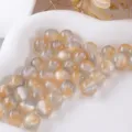 Detailed close-up of amber resin glitter beads showing shimmering texture for craft use. - Size 10