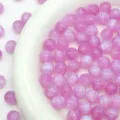 Close-up detail of glossy pink starry resin beads for DIY jewelry making and crafting supply. - Magenta Purple
