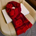 Detailed view of a festive red winter scarf featuring traditional woven auspicious patterns and tassels. - Auspicious Fortune and Blessings