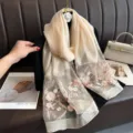 Exquisite silk scarf detail showing delicate pink floral embroidery on champagne silk. - Khaki