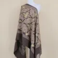 Detailed view of the brown cashmere shawl featuring intricate gold floral embroidery and fringe. - Dark Brown