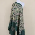Detail shot of dark green embroidered cashmere shawl with gold metallic floral design fringe. - Army Green