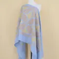 Detail view of a light blue cashmere shawl featuring elegant gold floral embroidery. - Lake Blue