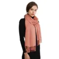 Detail view of solid color peach pink tassel scarf with soft cashmere-feel fabric. - Coral Pink (007)