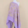Close-up of the delicate gold floral embroidery and soft lavender cashmere texture of the shawl. - Lavender