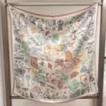 Detailed view of luxury silk square scarf featuring vintage stamp patterns and hand-rolled hem. - Time Postmark RY-07