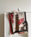 Close-up detail of vintage Leaning Tower of Pisa and red rose jacquard woven throw blanket. - Leaning Tower Rose